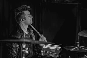 Remote session drummer playing rock beats on drum kit